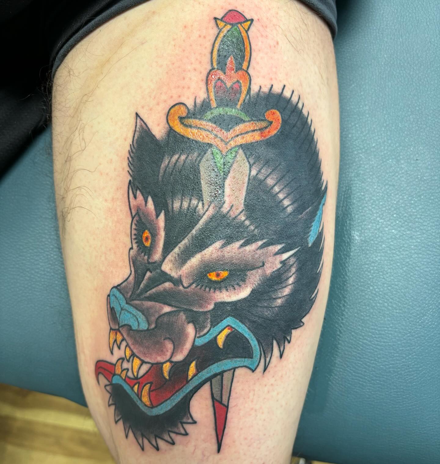 Wolf American traditional tattoo on the thigh by Rene Chavira