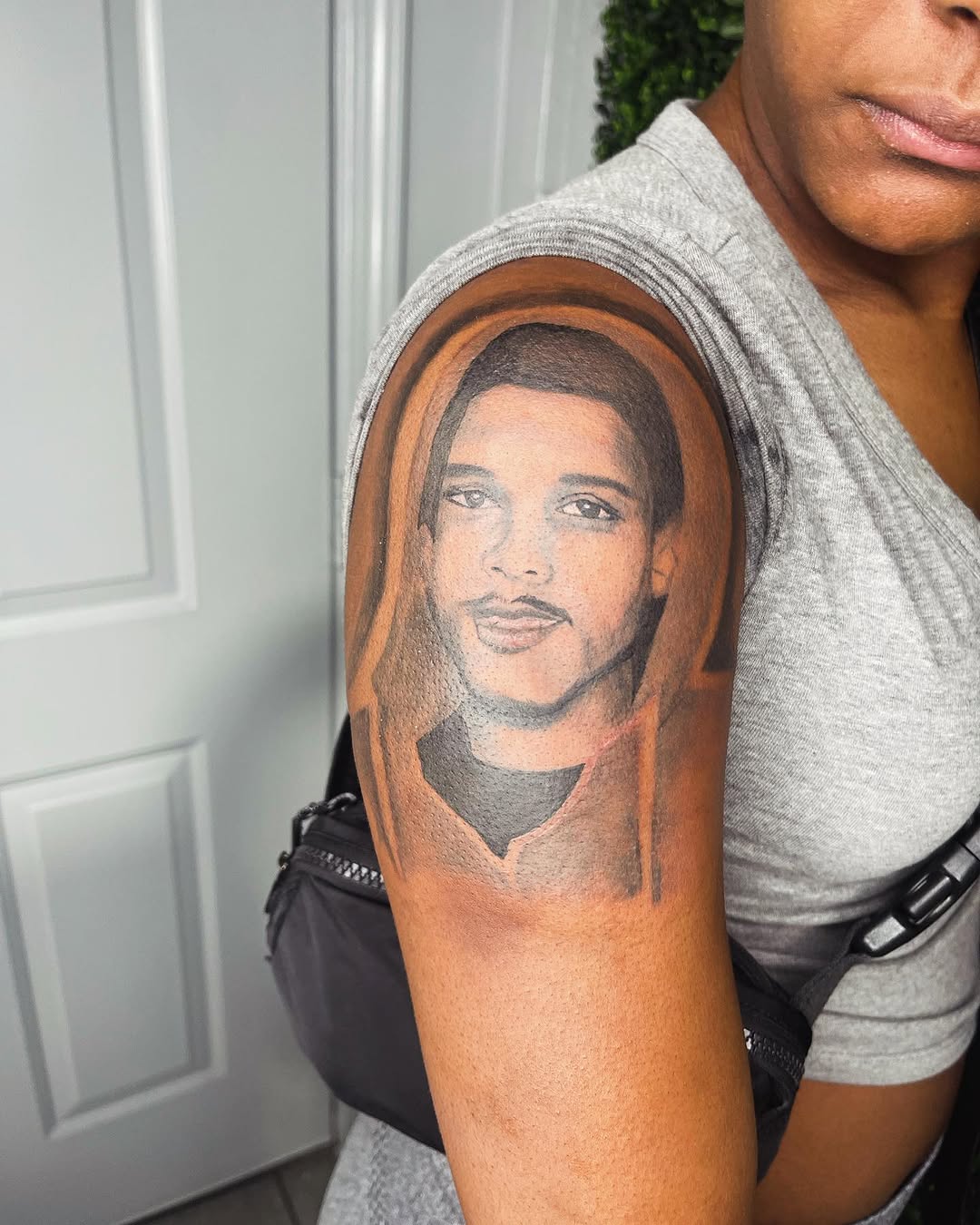 Portrait of a man realism tattoo on the upper arm by Uncle Fade Tattoo Artist ✍🏾