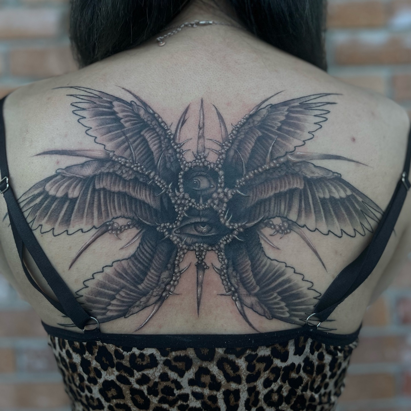 Moth geometric tattoo on the back by Myla Jane, Houston, Texas
