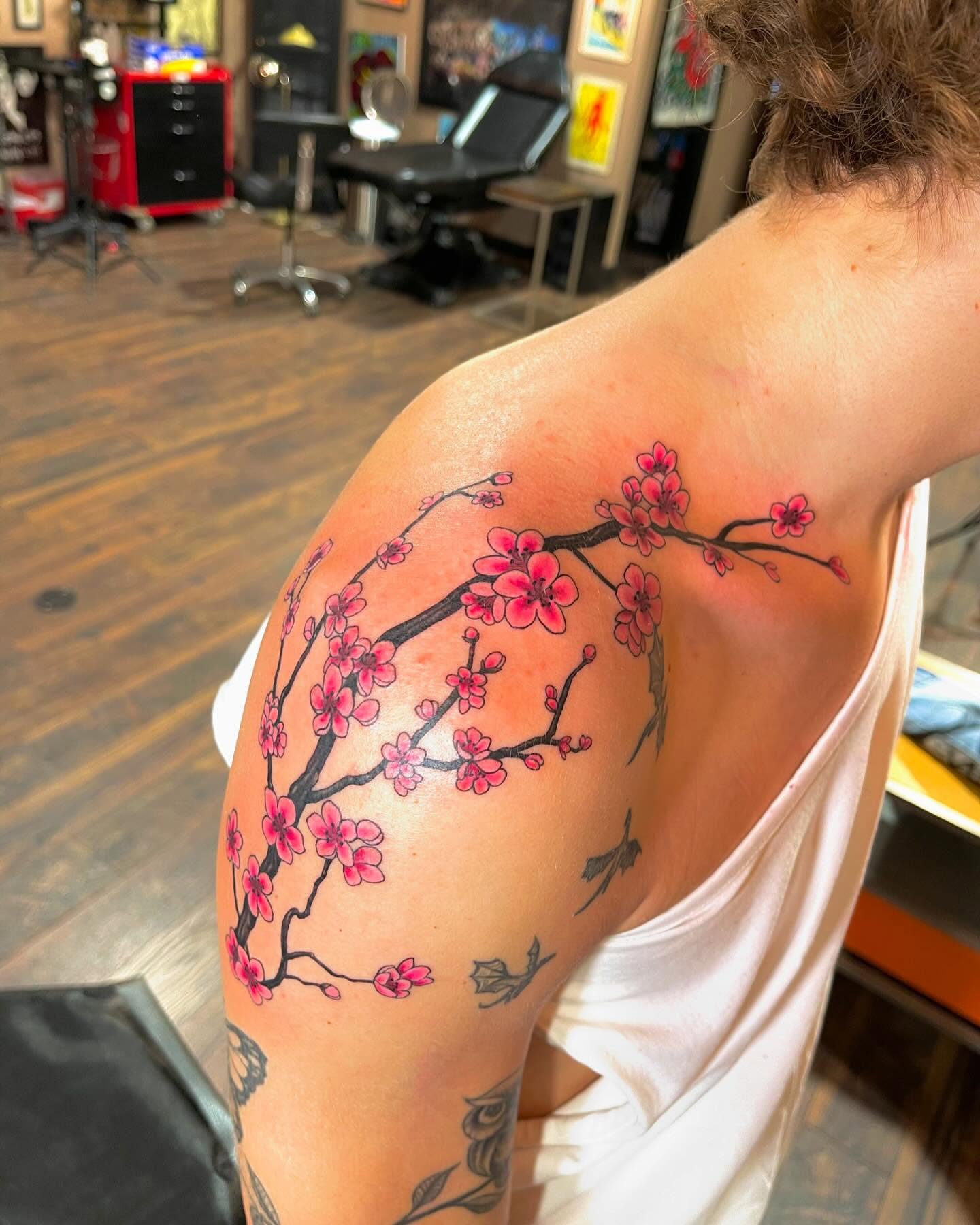 Cherry blossom branch dotwork tattoo on the shoulder by Jevon Glasco Tattoos