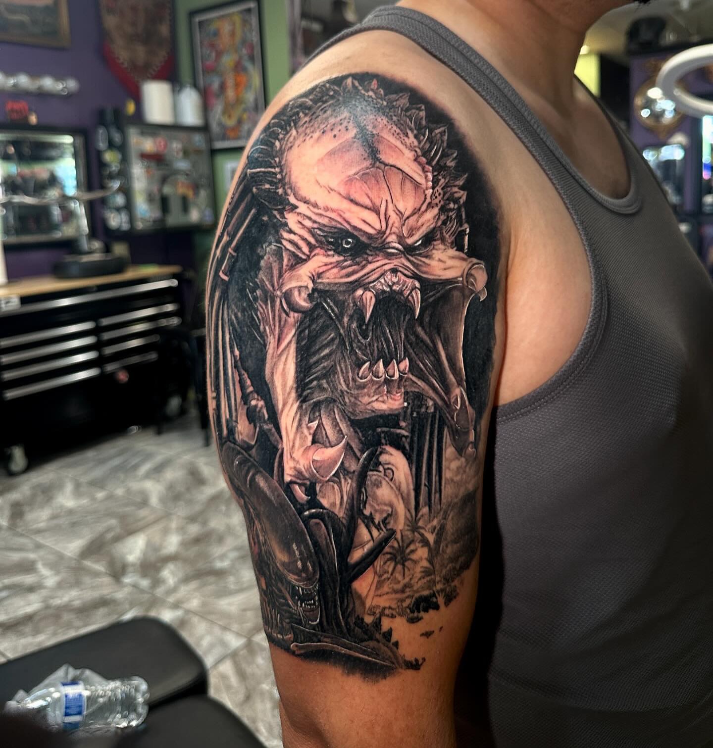 Predator realism tattoo on the upper arm by Billy Harris