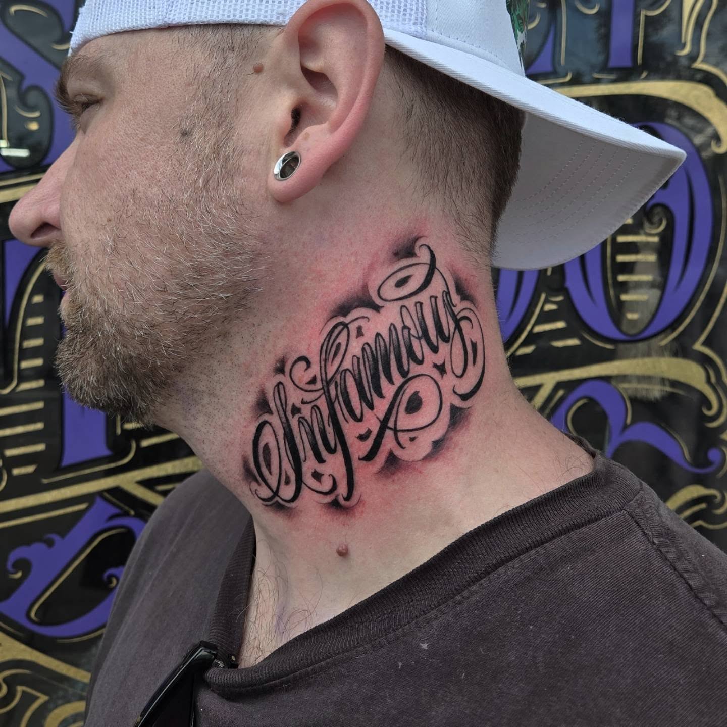 Infamous lettering script tattoo on the neck by DiazTattoos, Denver, Colorado
