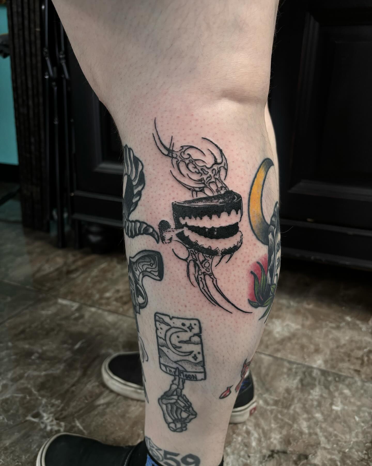 Monster dotwork tattoo on the calf by Ares Rhodes