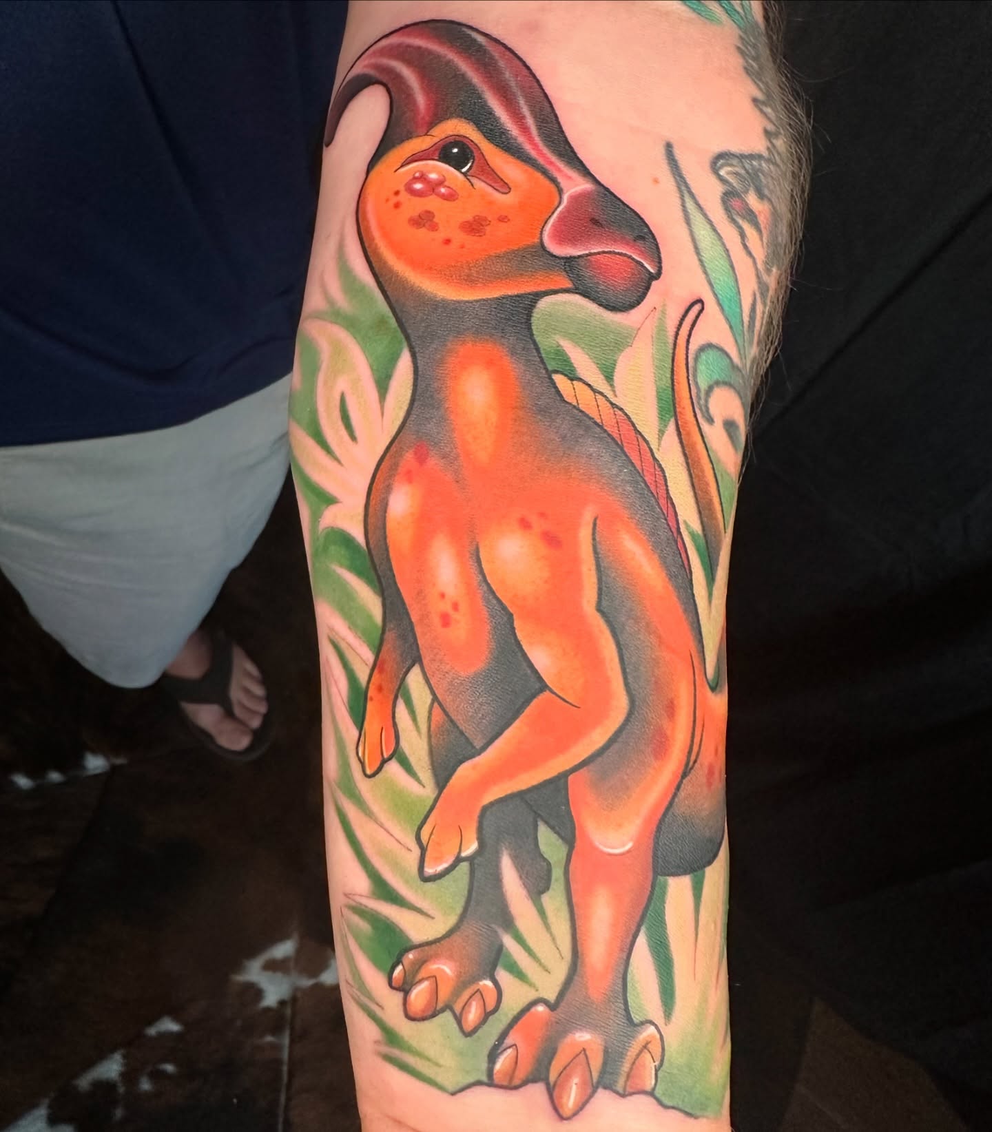 Dinosaur new school tattoo on the forearm by B.G. Germershausen