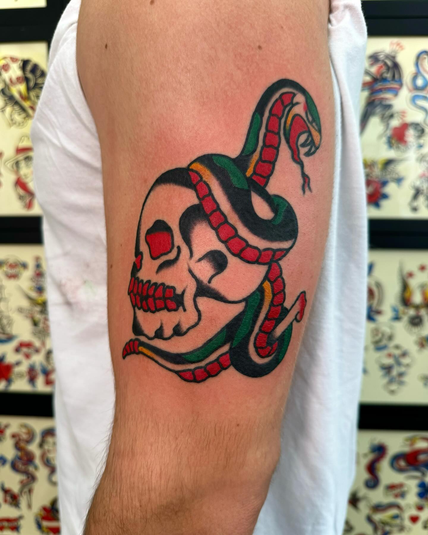 Skull with snake American traditional tattoo on the forearm by Nicholas Mella, Nashville, Tennessee
