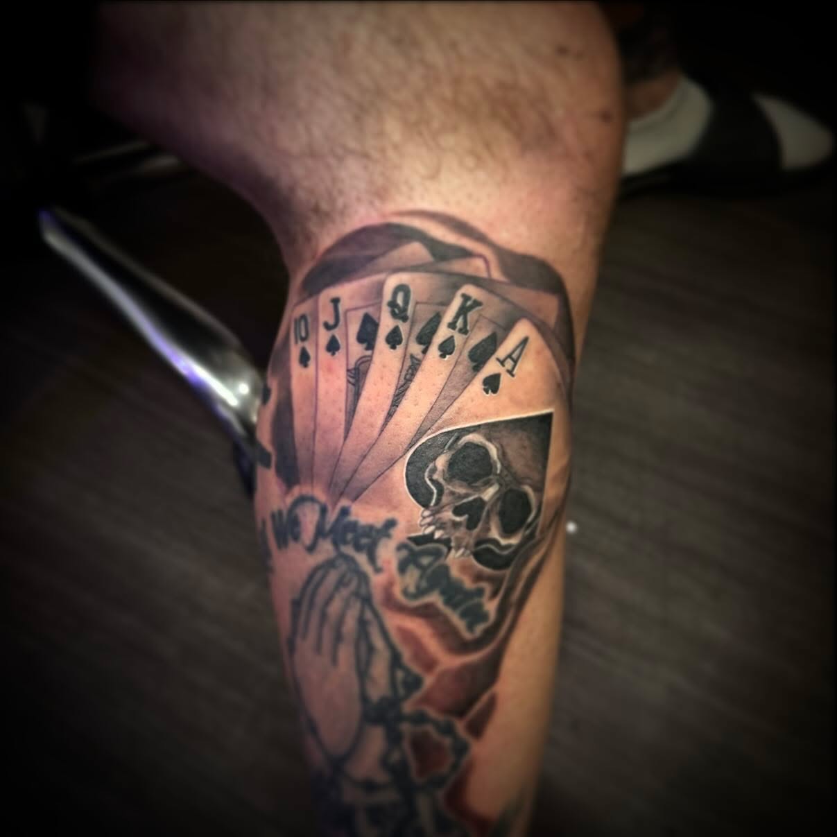 Playing cards and skull realism tattoo on the forearm by Oscar Arias