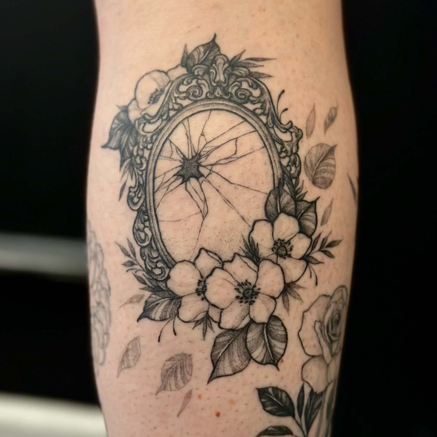 Broken mirror with flowers ornamental tattoo on the forearm by Sabrina, Harrison, New Jersey