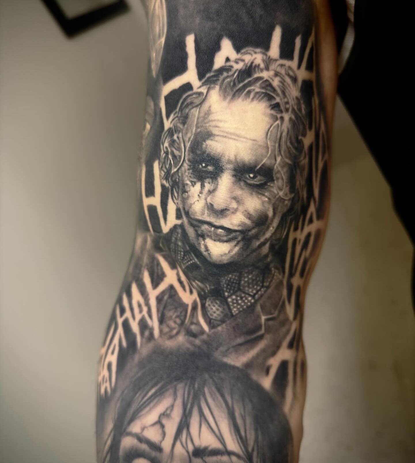 Joker realism tattoo on the forearm by Dale DeVille