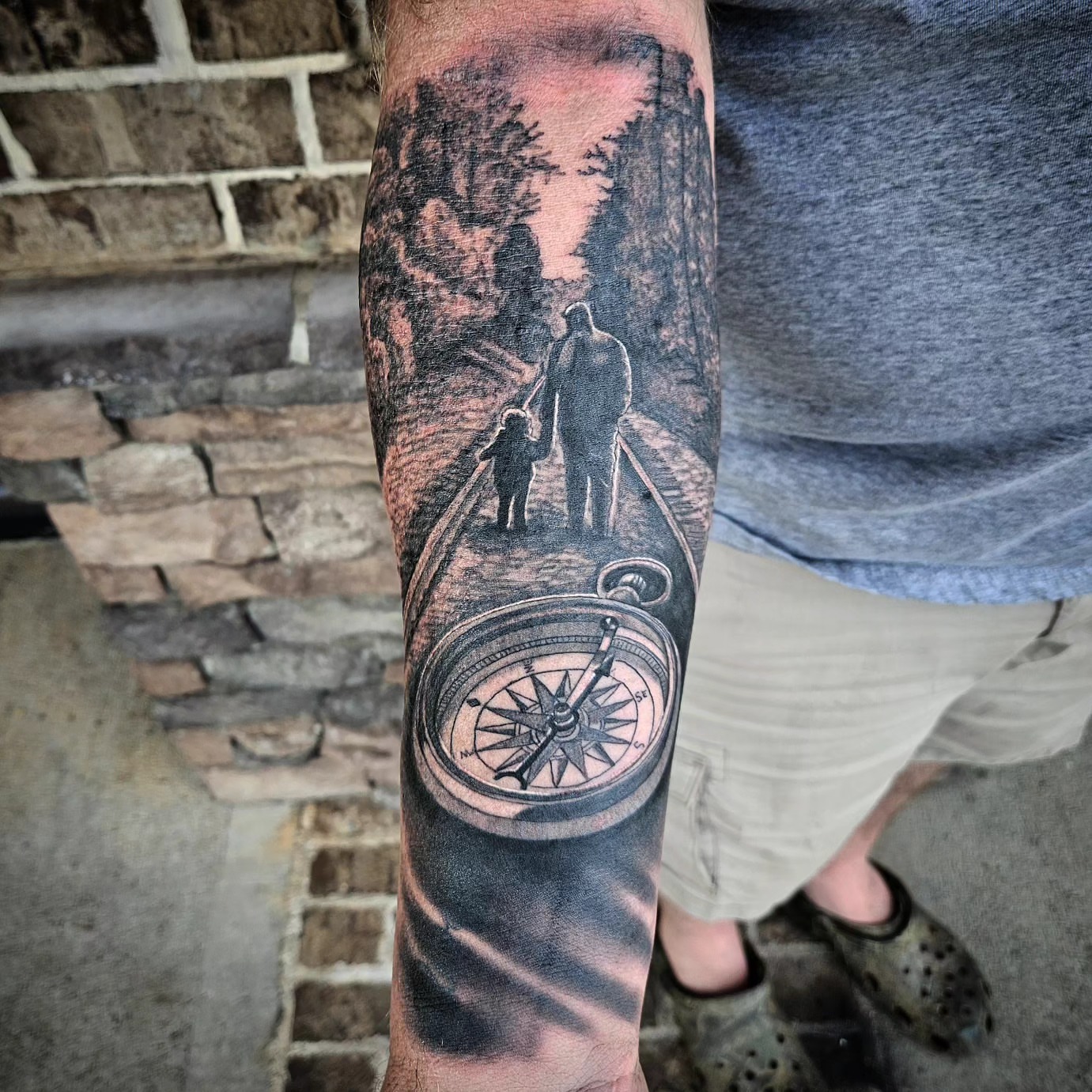 Compass and family realism tattoo on the forearm by Mike Bugenhagen