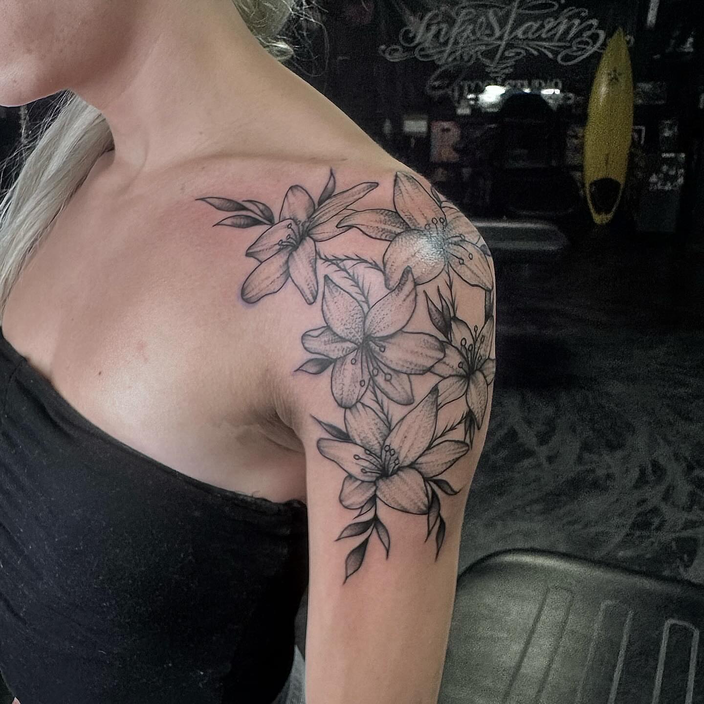 Lilies black and grey tattoo on the shoulder by Colby McClain