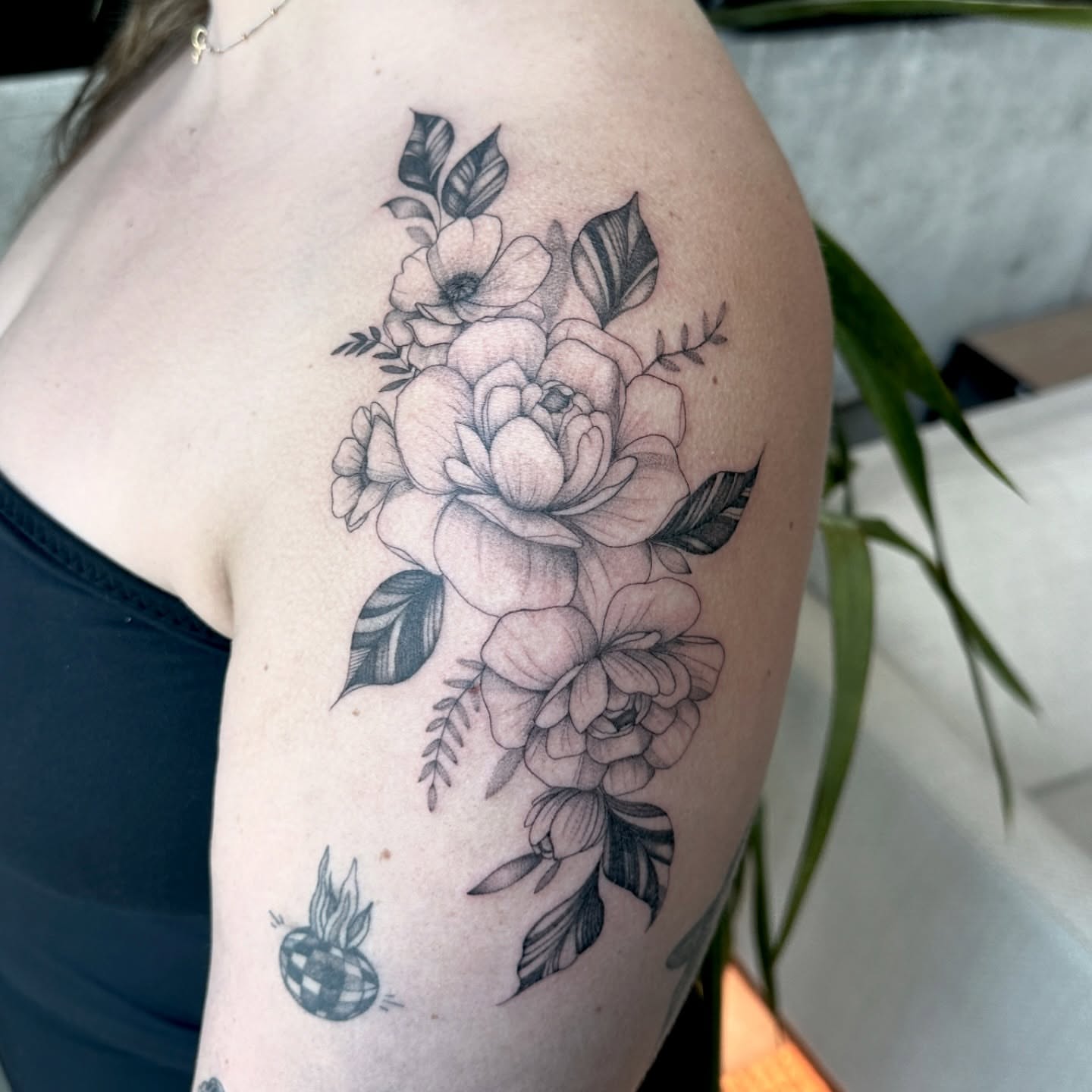 Floral bouquet black and grey tattoo on the shoulder by Rachel