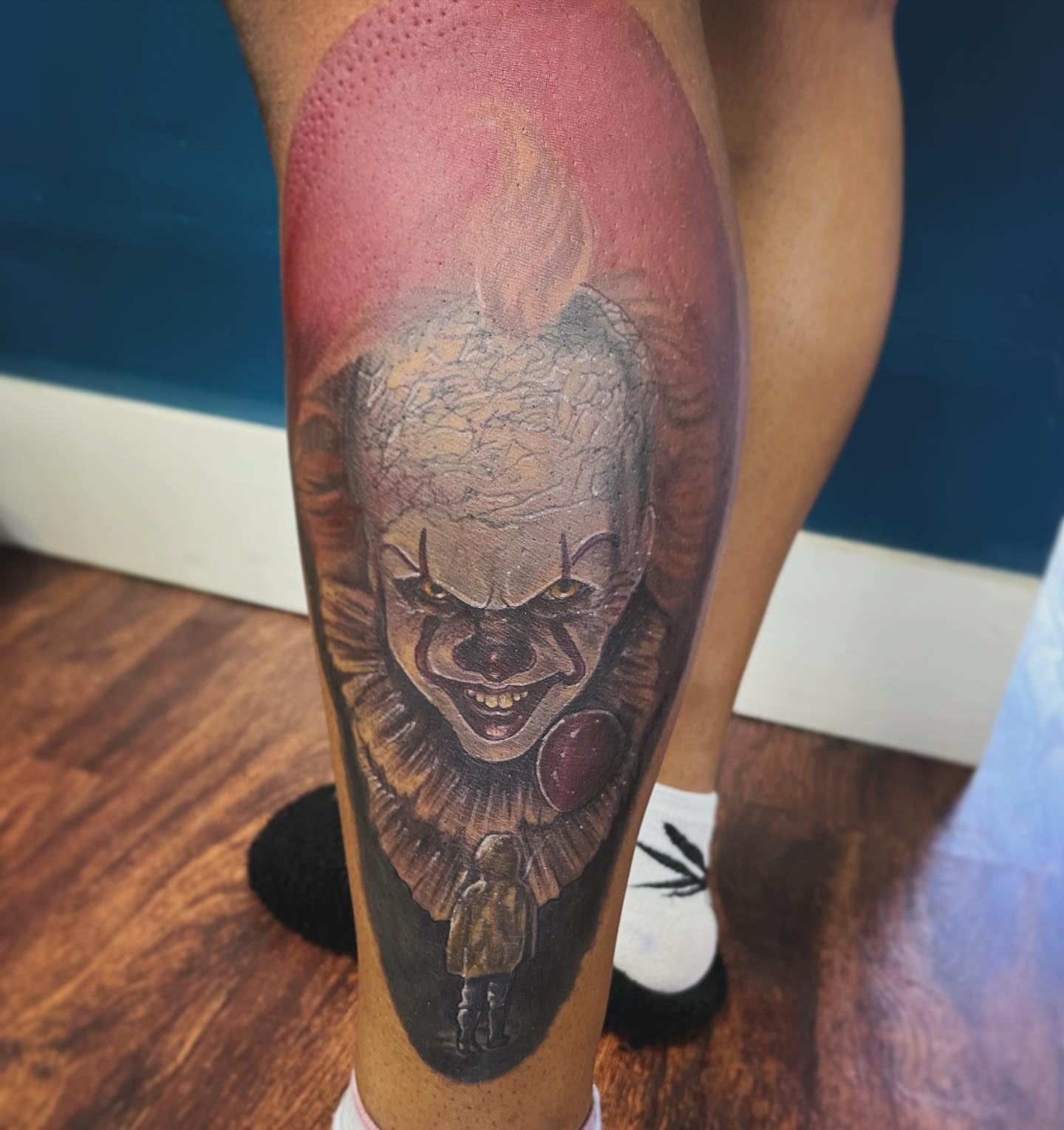 Pennywise the Clown realism tattoo on the leg by Darius Armour (Tattoo Artist)