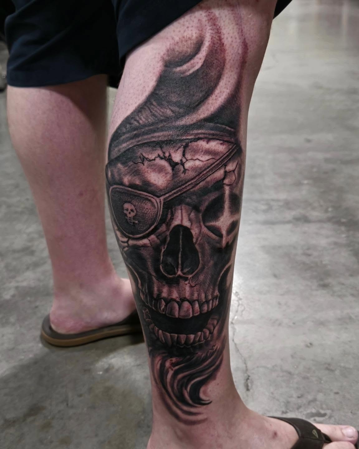 Skull wearing sunglasses realism tattoo on the calf by Cody Lambert
