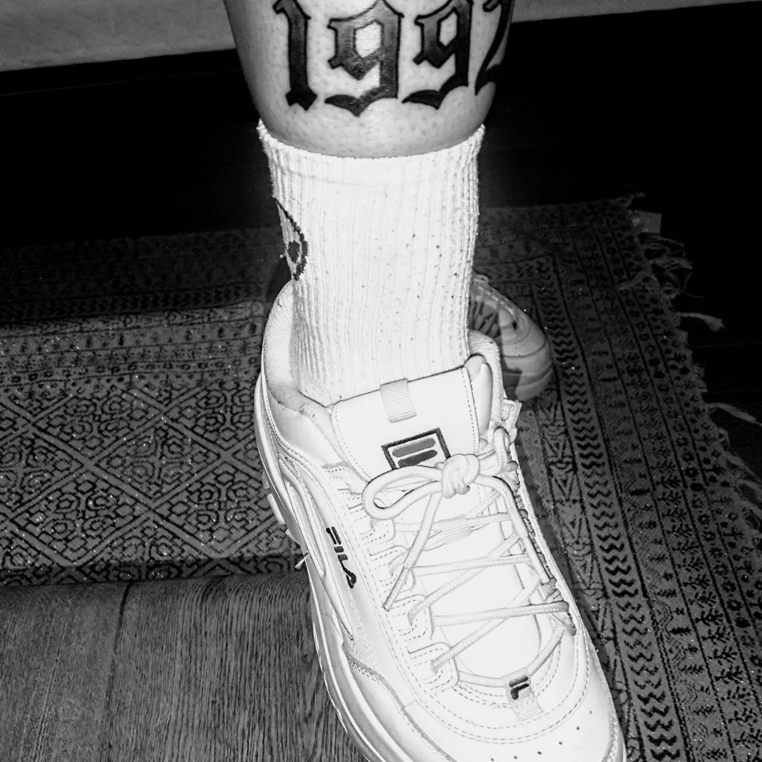 Numbers lettering script tattoo on the forearm by jim collins, Dayton, Ohio