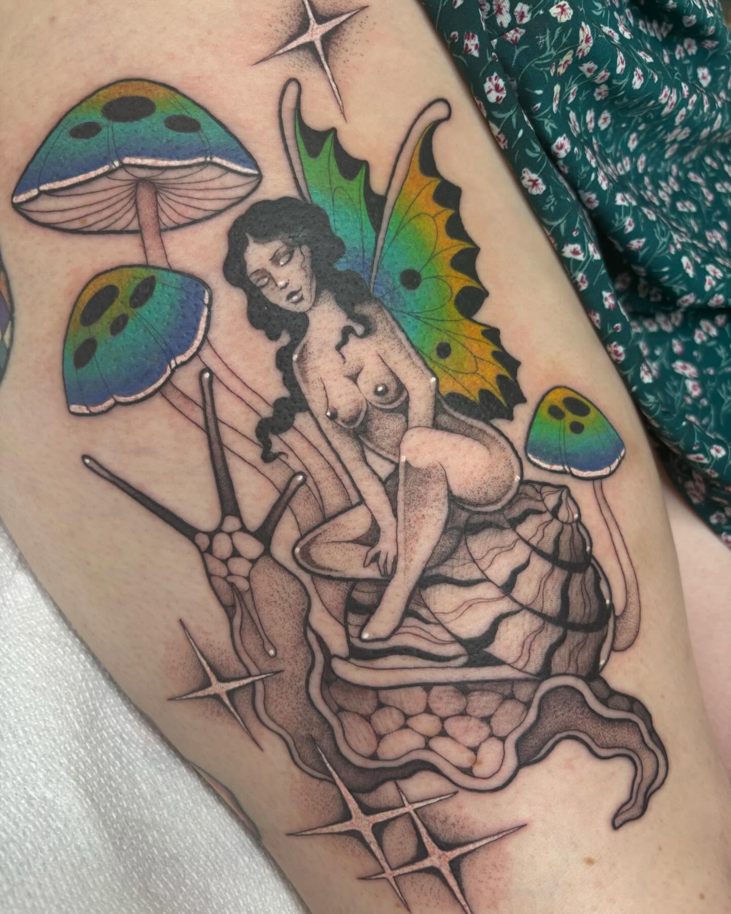 Fairy and mushrooms new school tattoo on the thigh by Carly Zehring