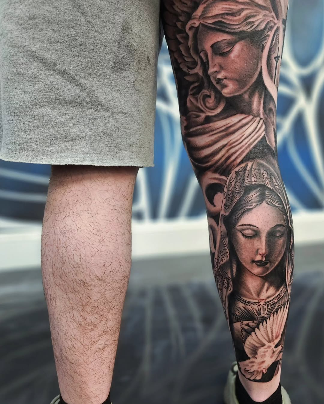 Religious figures with dove Chicano tattoo on the forearm by Jo'el Acoba