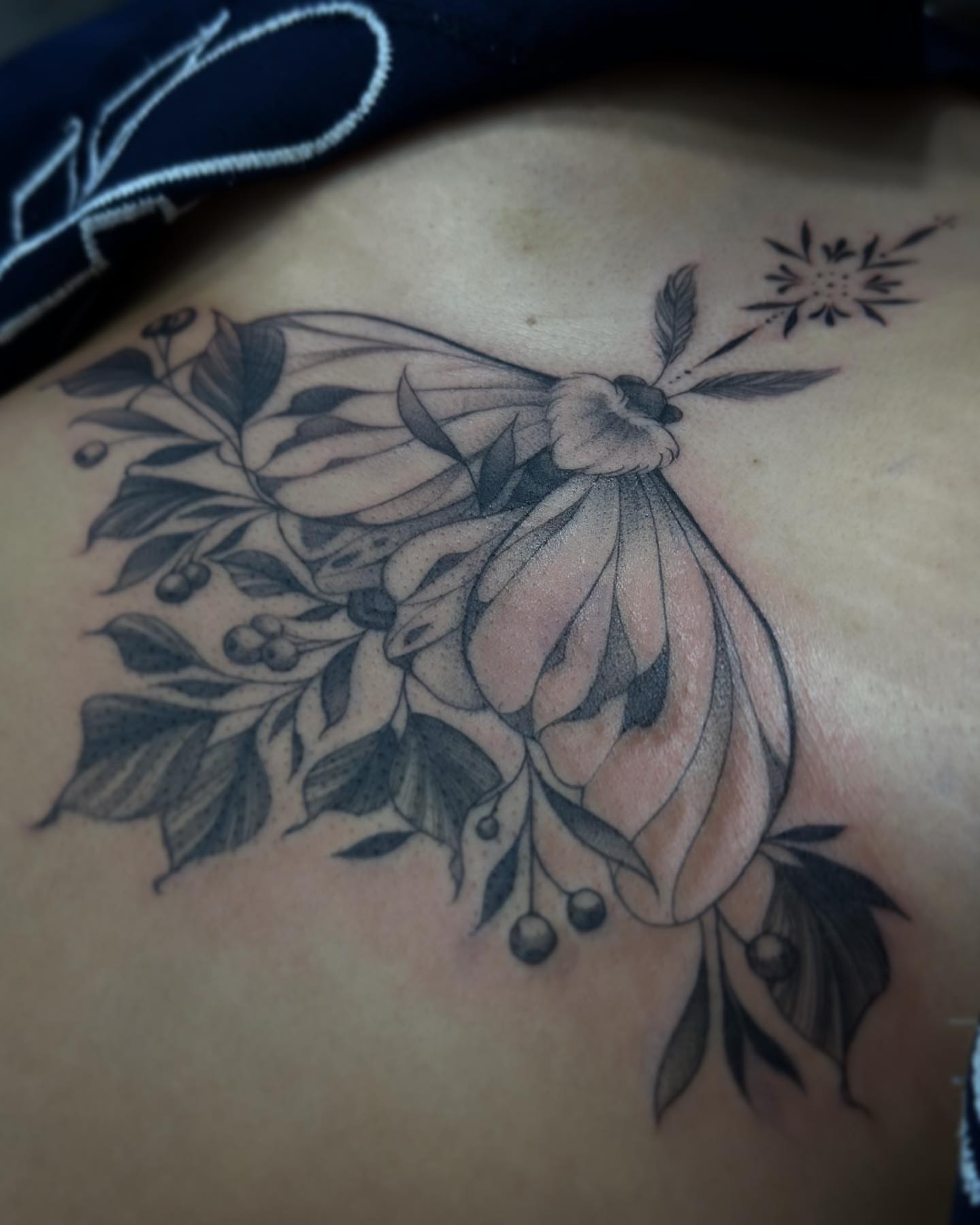 Butterfly and floral black and grey tattoo on the shoulder by audi