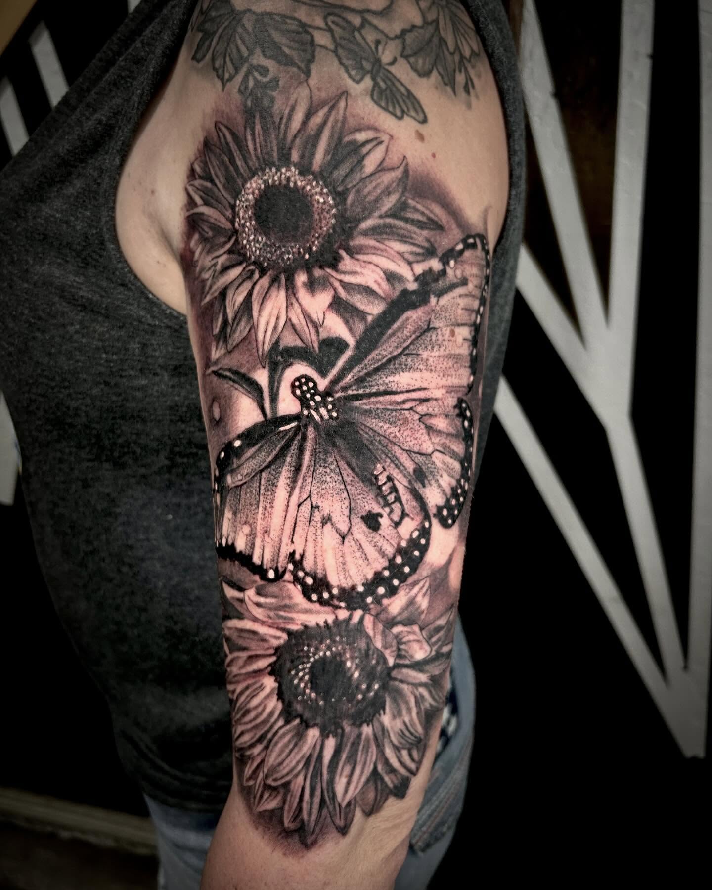Sunflower and butterfly dotwork tattoo on the forearm by Sean Cavanaugh