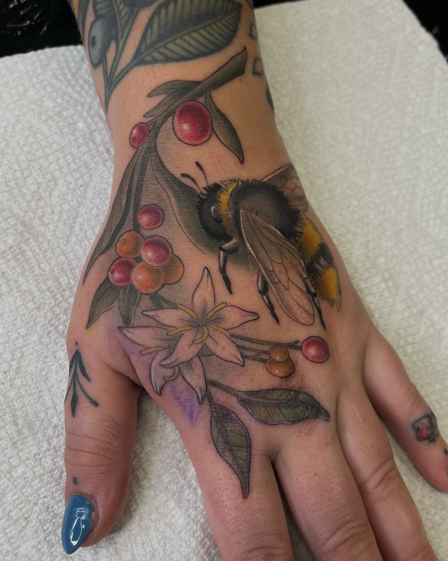 Bee and berries realism tattoo on the hand by ๐๐๐๐๐๐๐