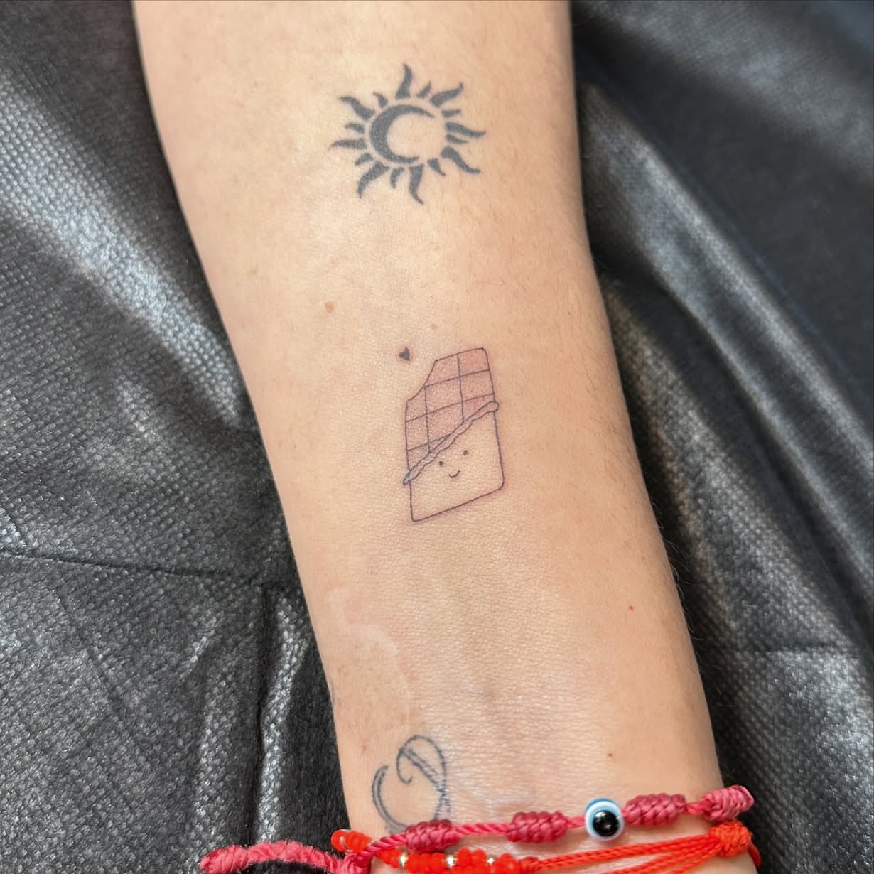 Chocolate bar minimalist tattoo on the forearm by Dennis Alejandro