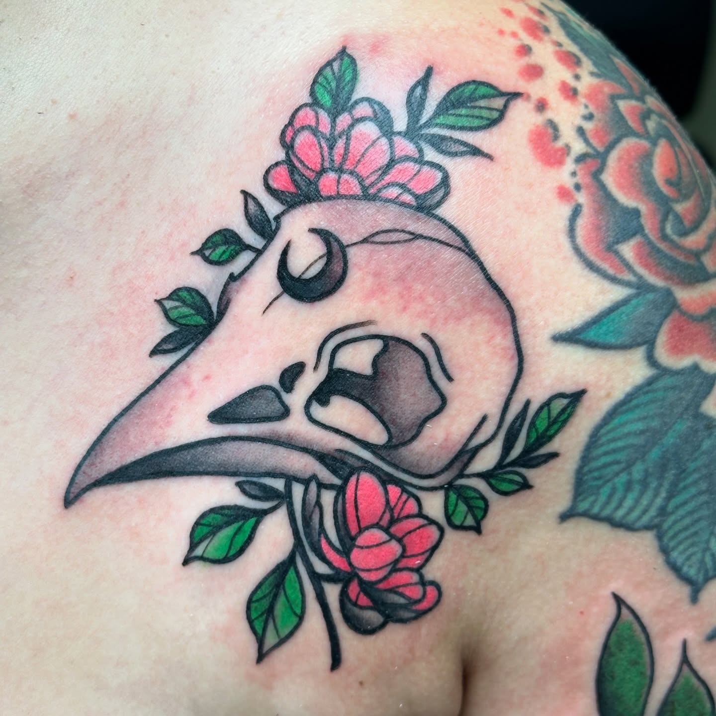 Bird skull with roses American traditional tattoo on the shoulder by New York Tattoo Artist