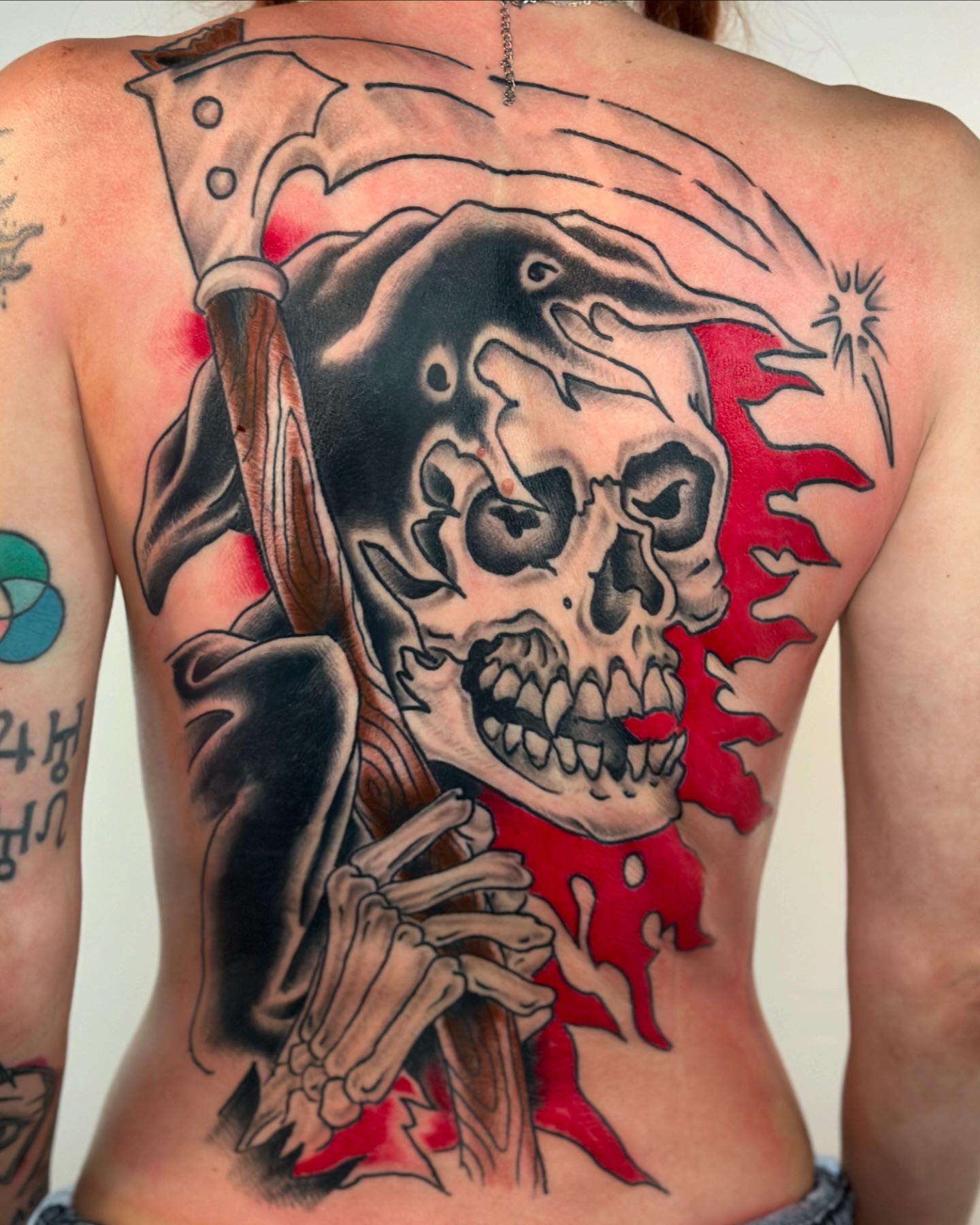 Skull and scythe American traditional tattoo on the back by David Steed, Dallas, Texas