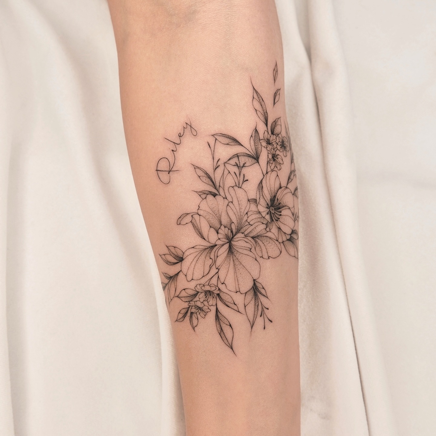 Floral bouquet realism tattoo on the forearm by Houston Tattoo Artist