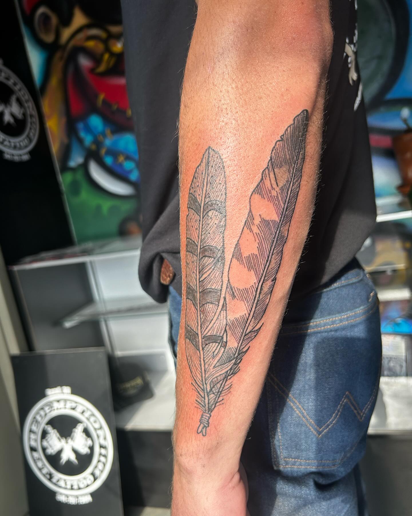 Feather black and grey tattoo on the forearm by goose 🪿