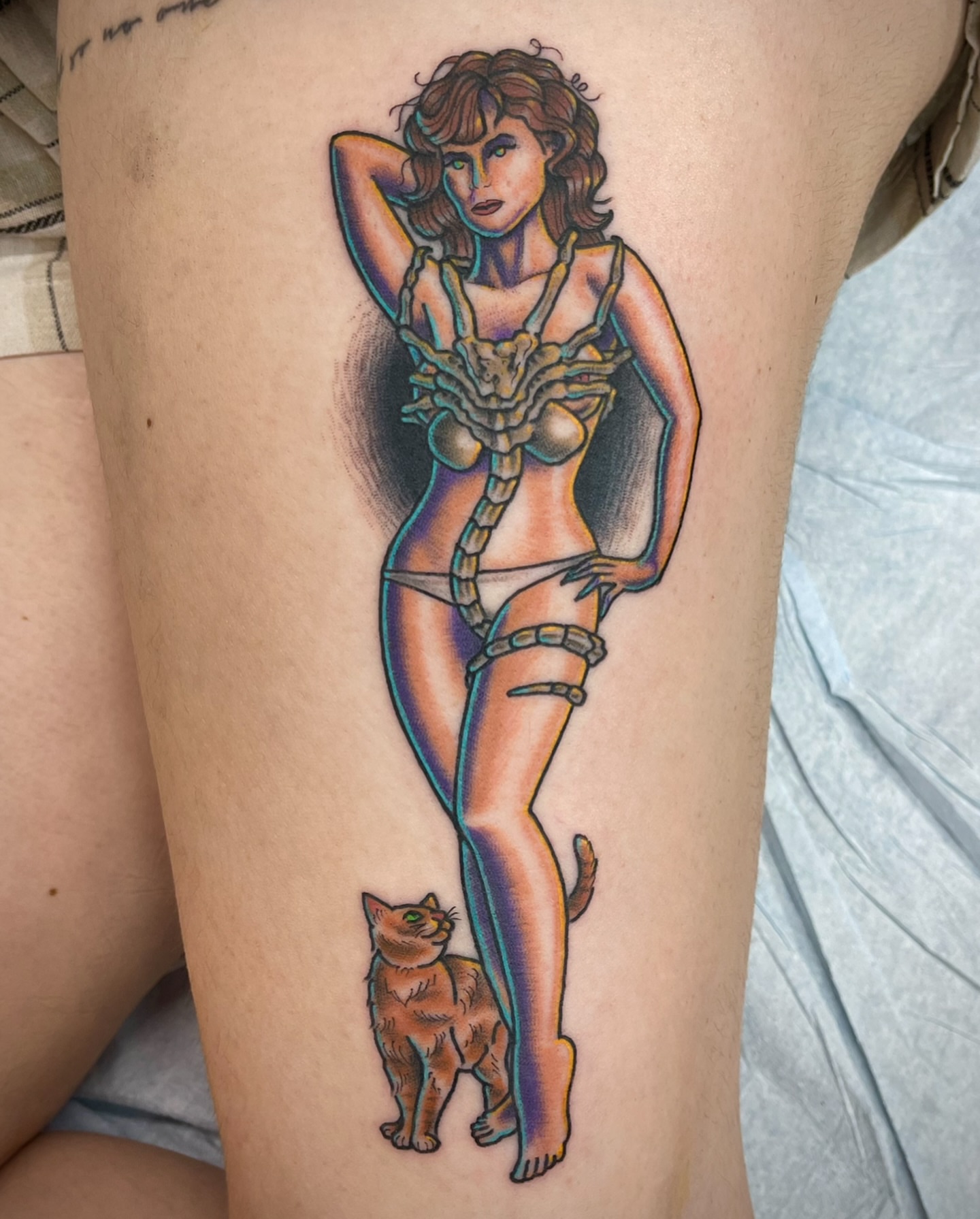 Woman with cat illustrative tattoo on the thigh by Thad Collis