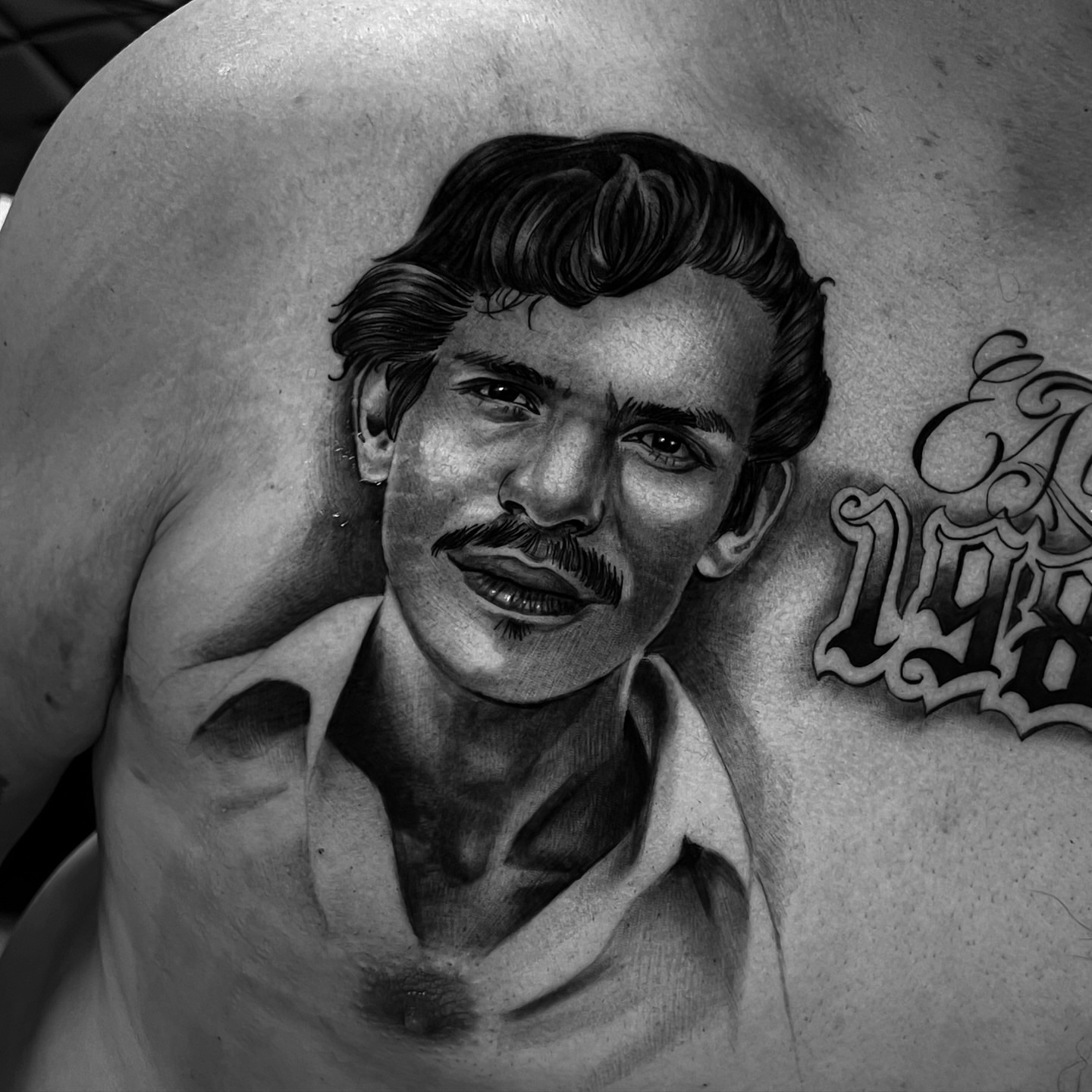 Portrait realism tattoo on the chest by Angel Lizarraga