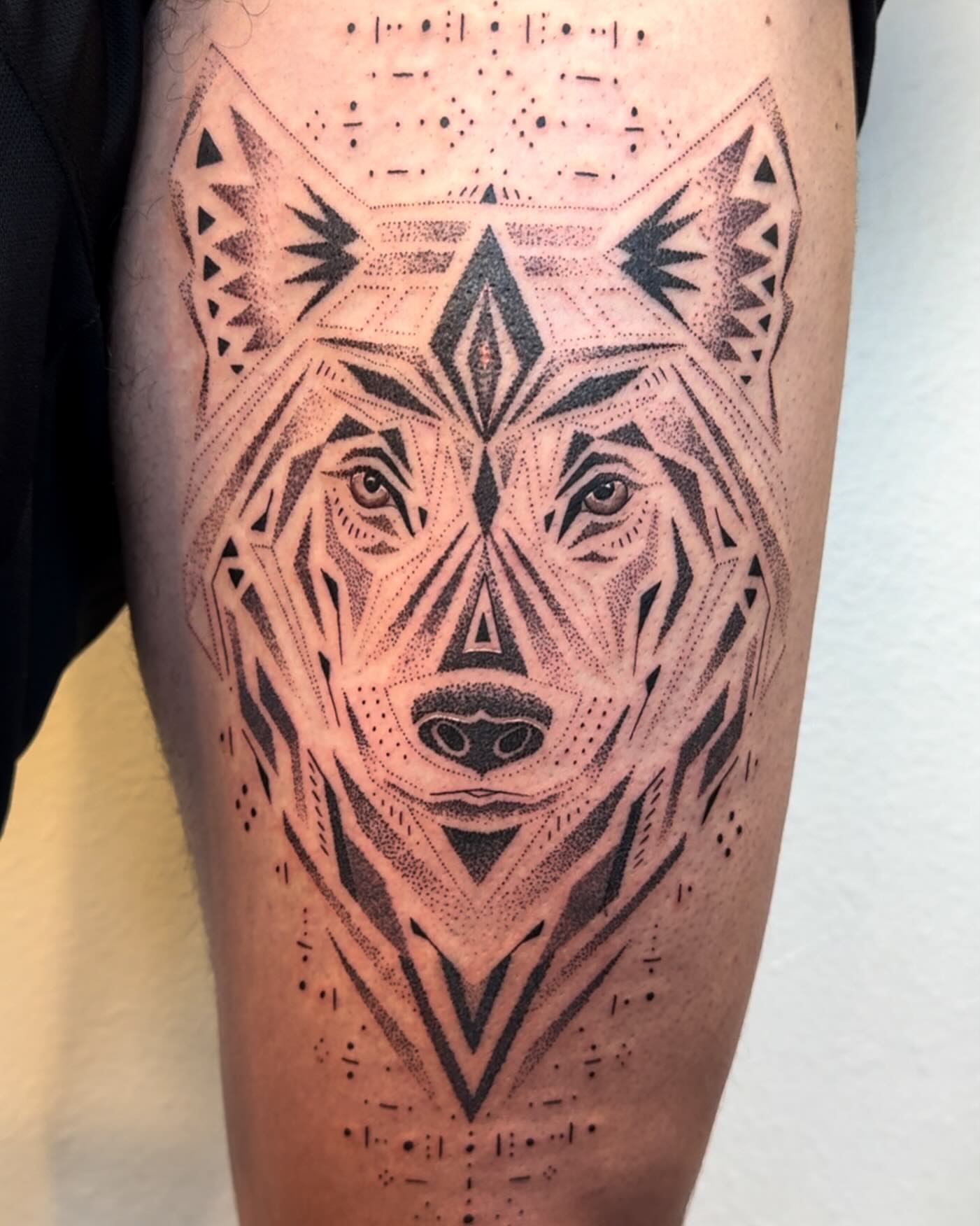 Wolf dotwork tattoo on the thigh by Ian Spencer