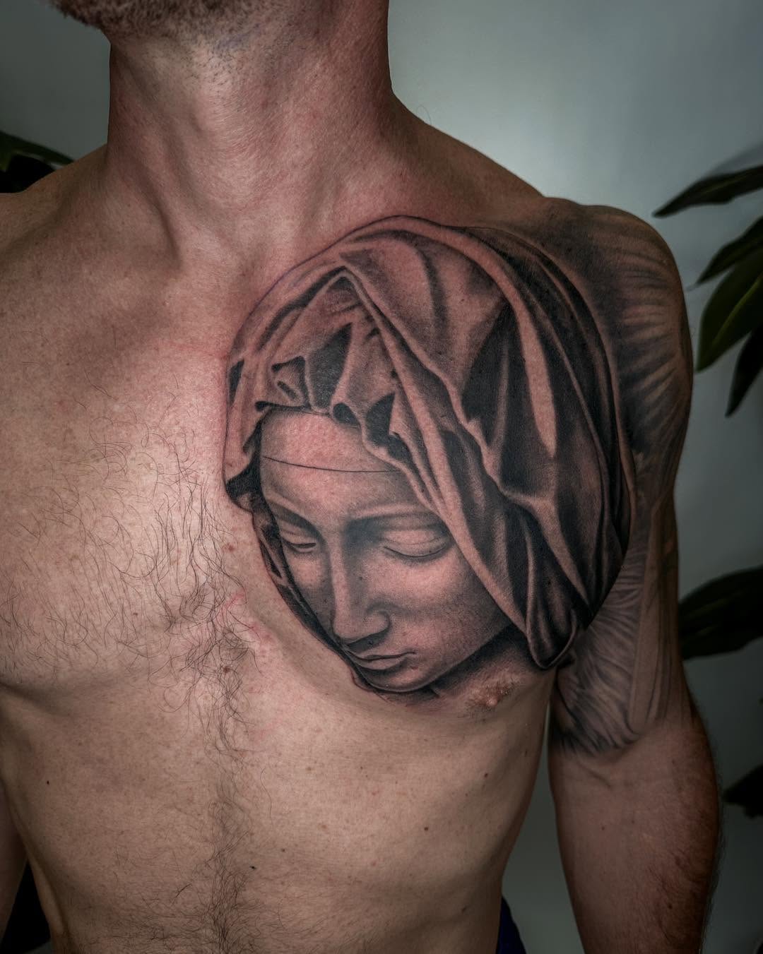 Sculptural face with draped cloth Chicano tattoo on the chest by James Hix - Tattoo Artist, Fort Worth, Texas
