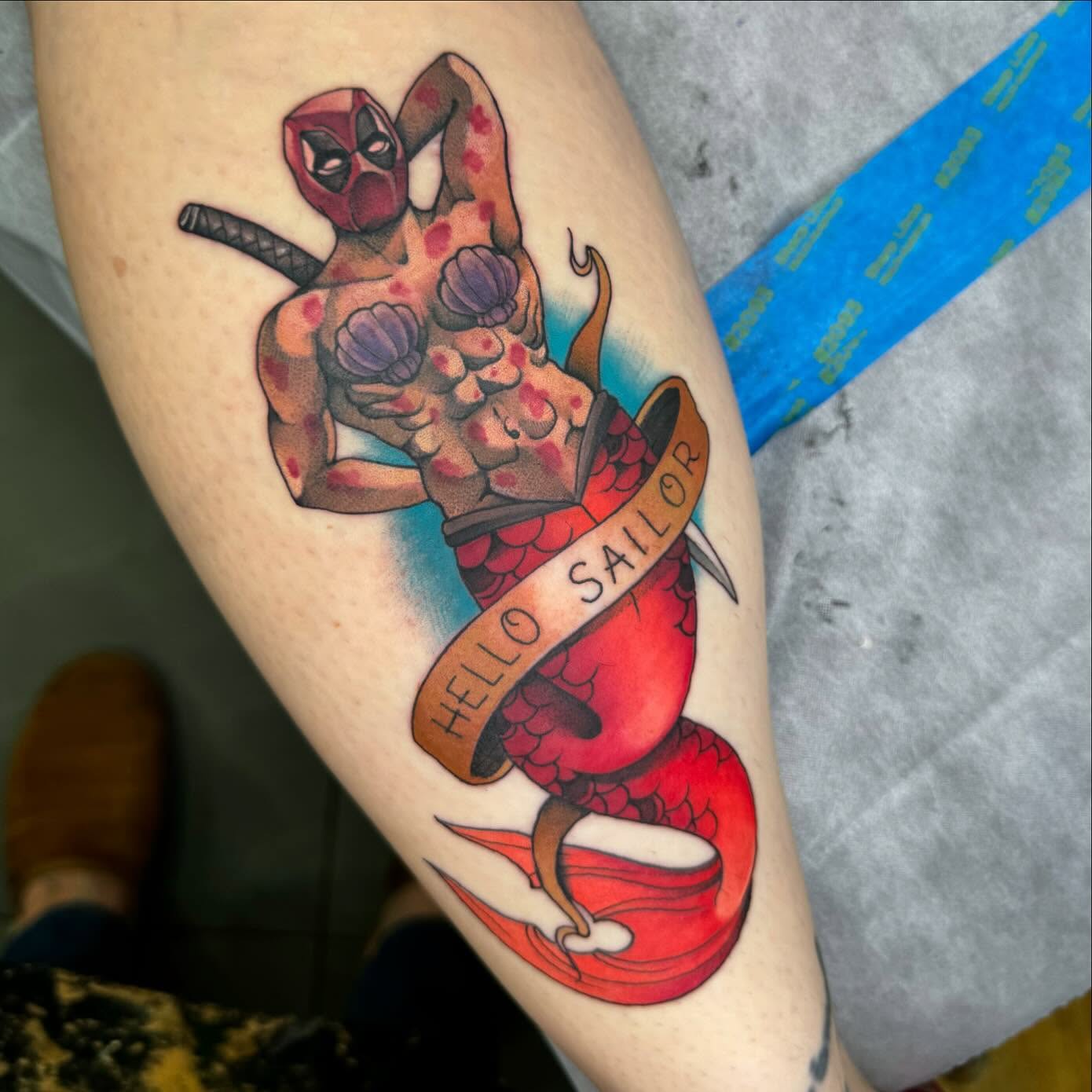 Mermaid and deadpool American traditional tattoo on the thigh by Ryan Futterman