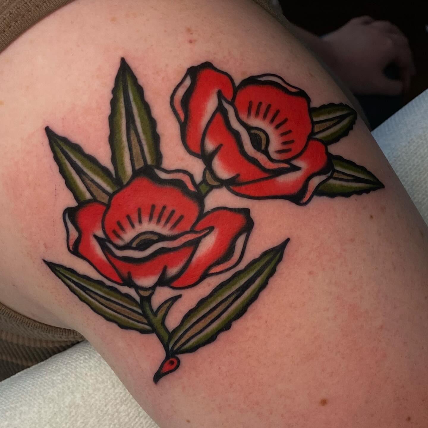Roses American traditional tattoo on the shoulder by Erin Chambers