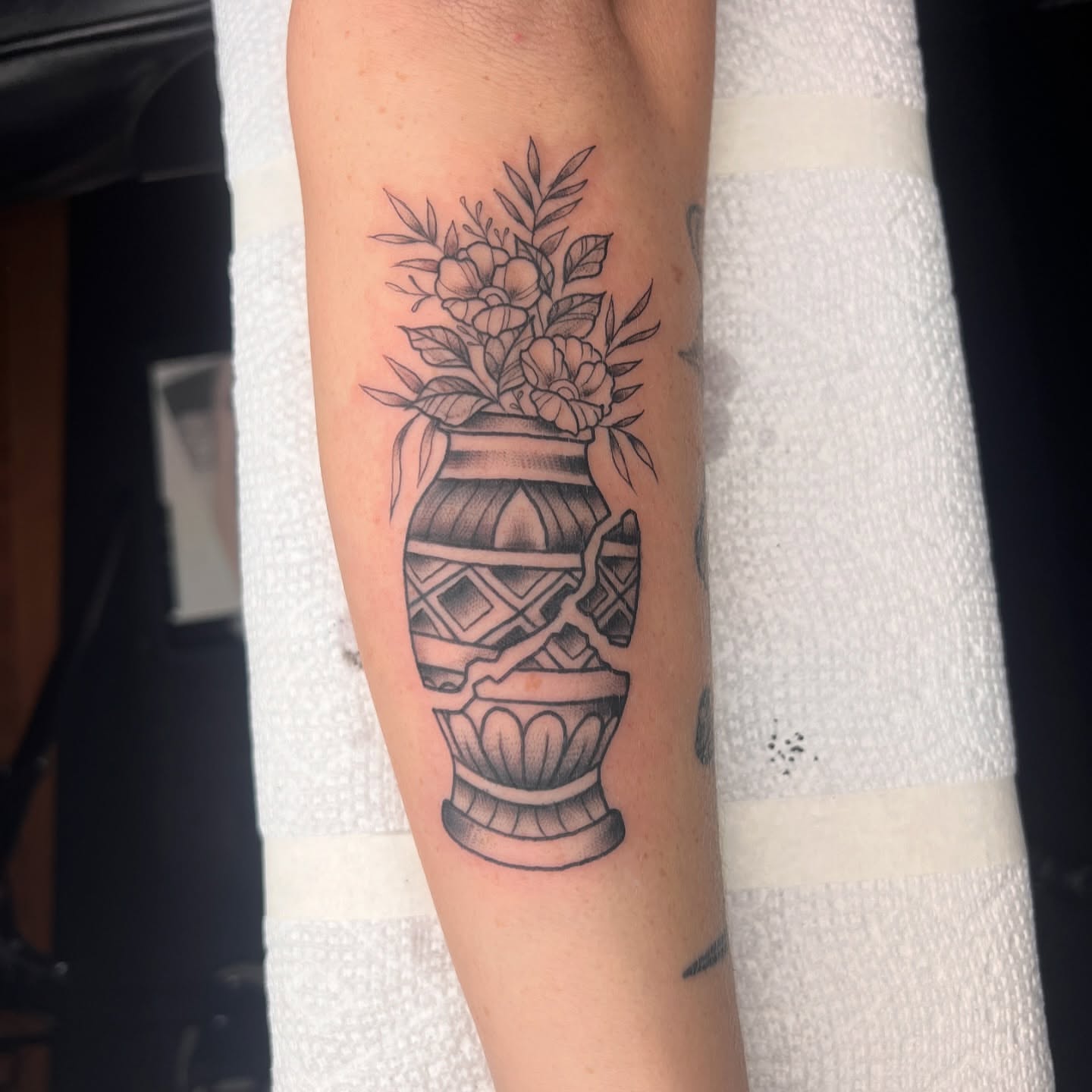 Vase with flowers black and grey tattoo on the forearm by Tattoo & Body Artist, Gastonia, North Carolina