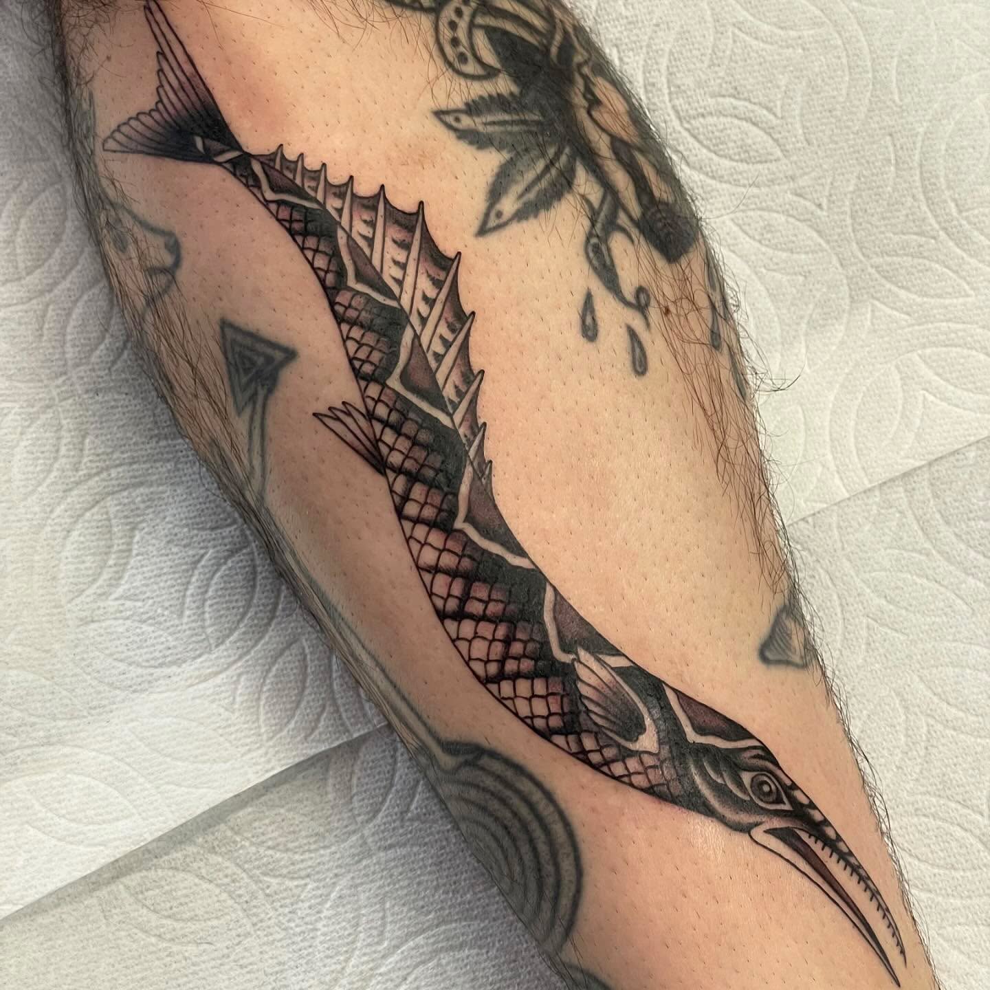 Swordfish black and grey tattoo on the forearm by Niko Mulhearn