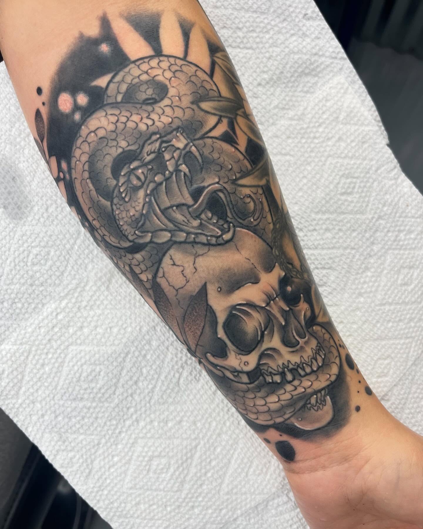 Dragon and skull realism tattoo on the forearm by Autumn Fulford