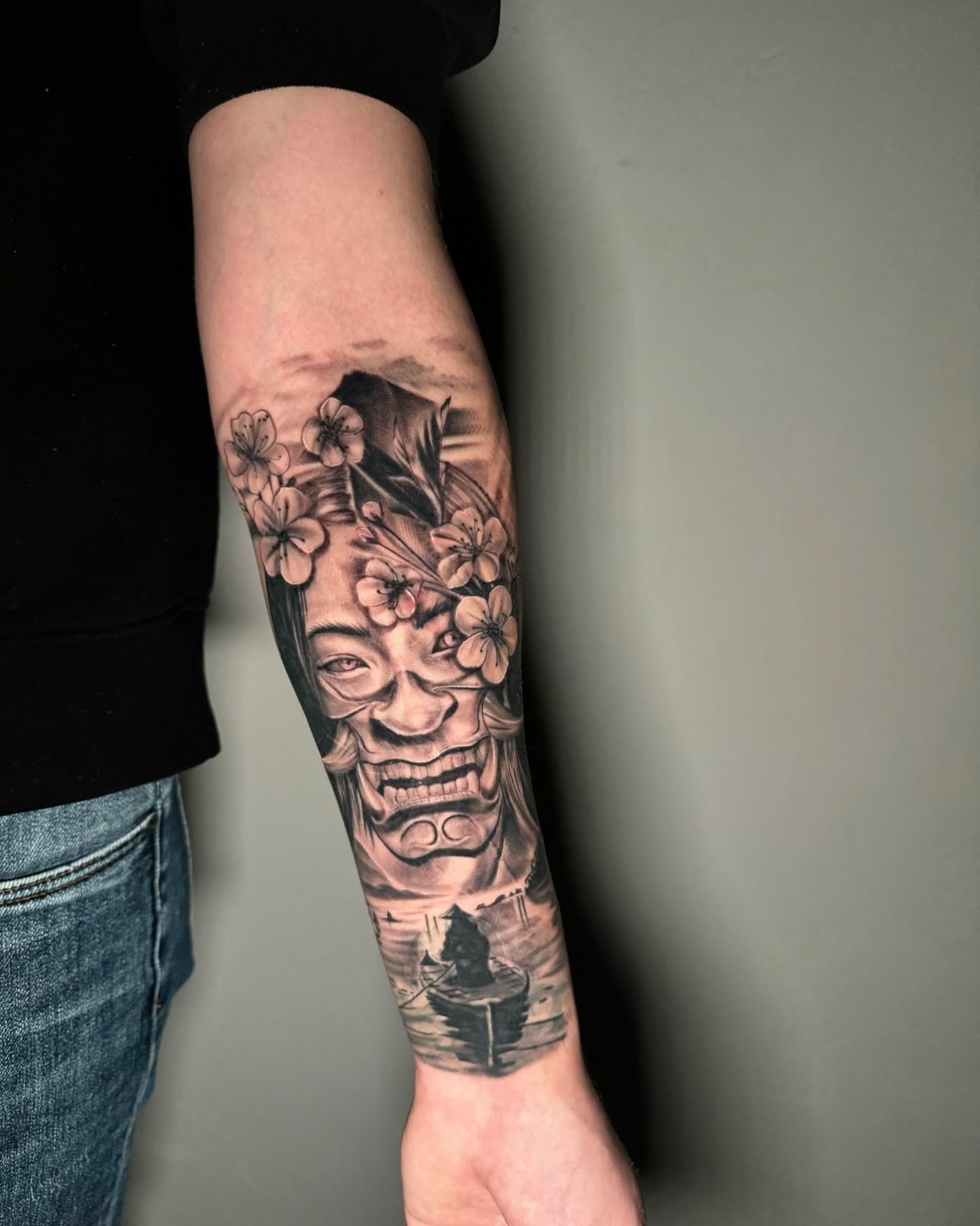 Mask with cherry blossoms realism tattoo on the forearm by Tattoo Artist πΊπΈ