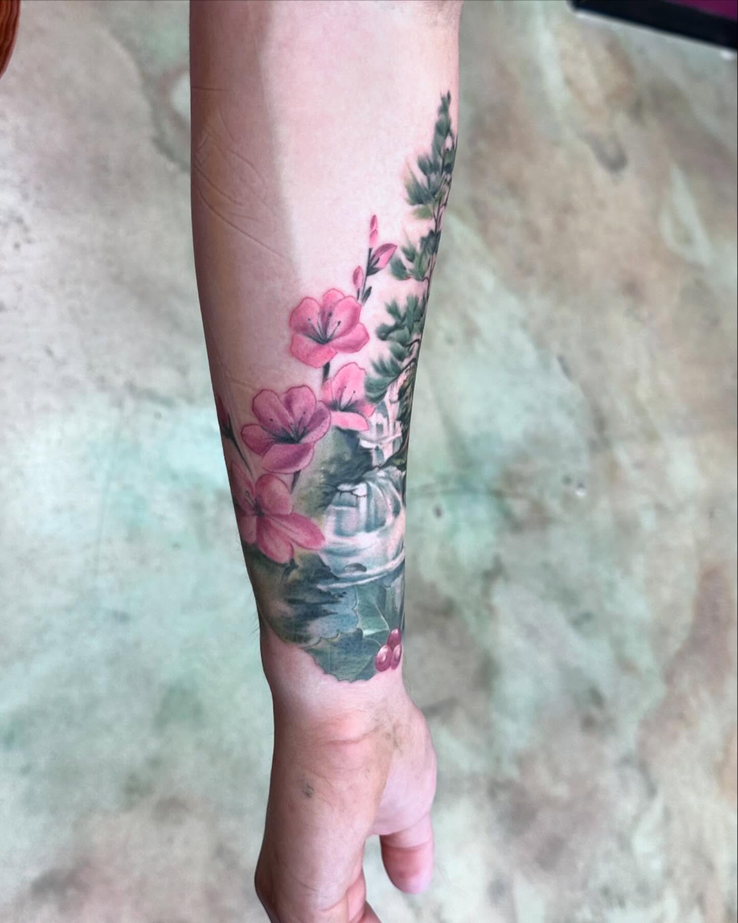Flowers and vase watercolor tattoo on the forearm by Shawn Cook