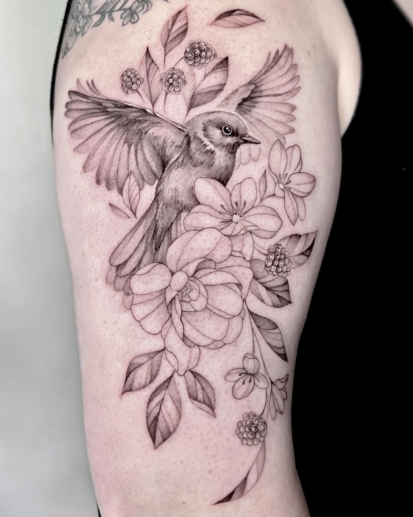 Bird and flowers realism tattoo on the forearm by Jax Citriglia