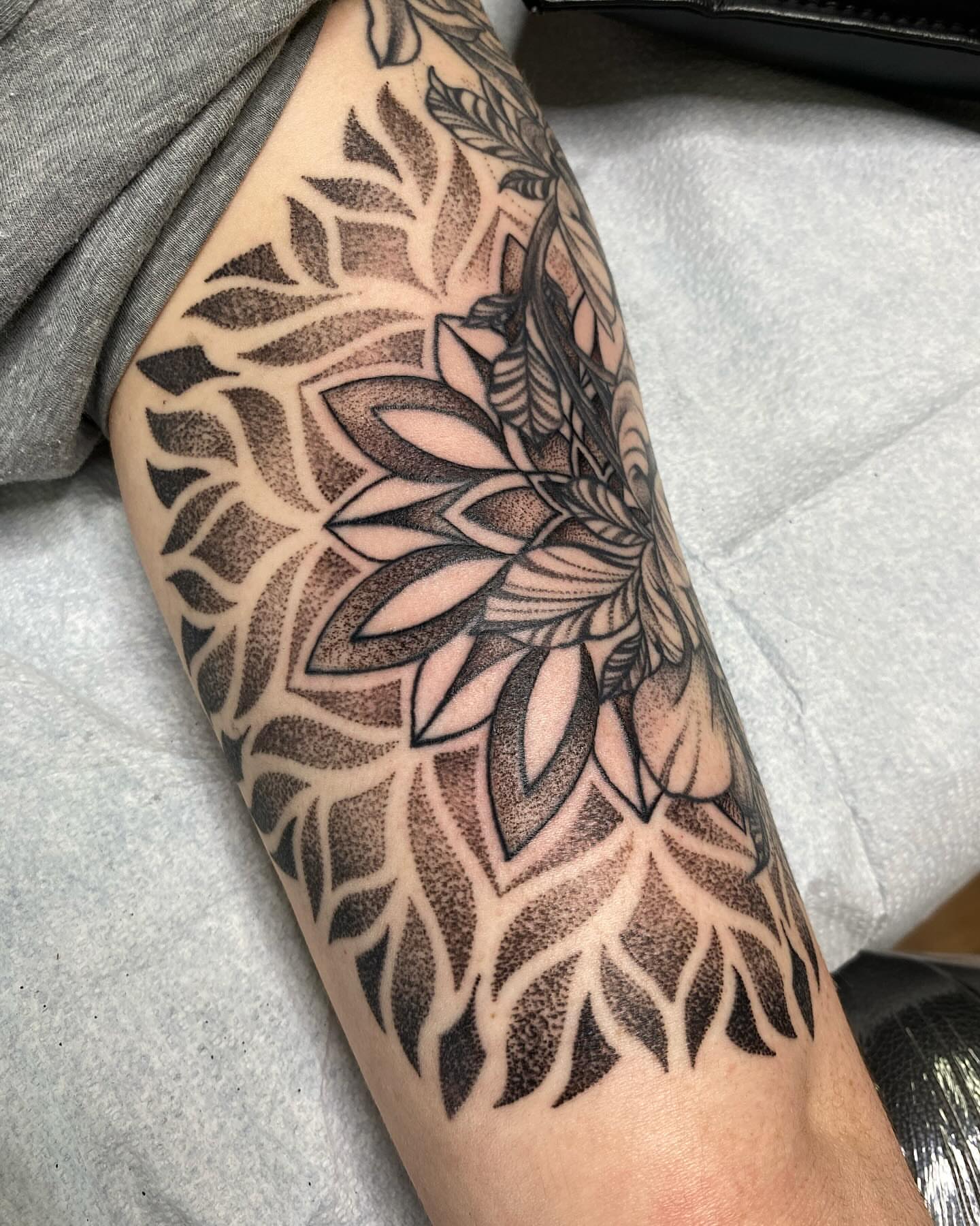 Lotus flower dotwork tattoo on the forearm by Taya Lynn, Hudson, Wisconsin