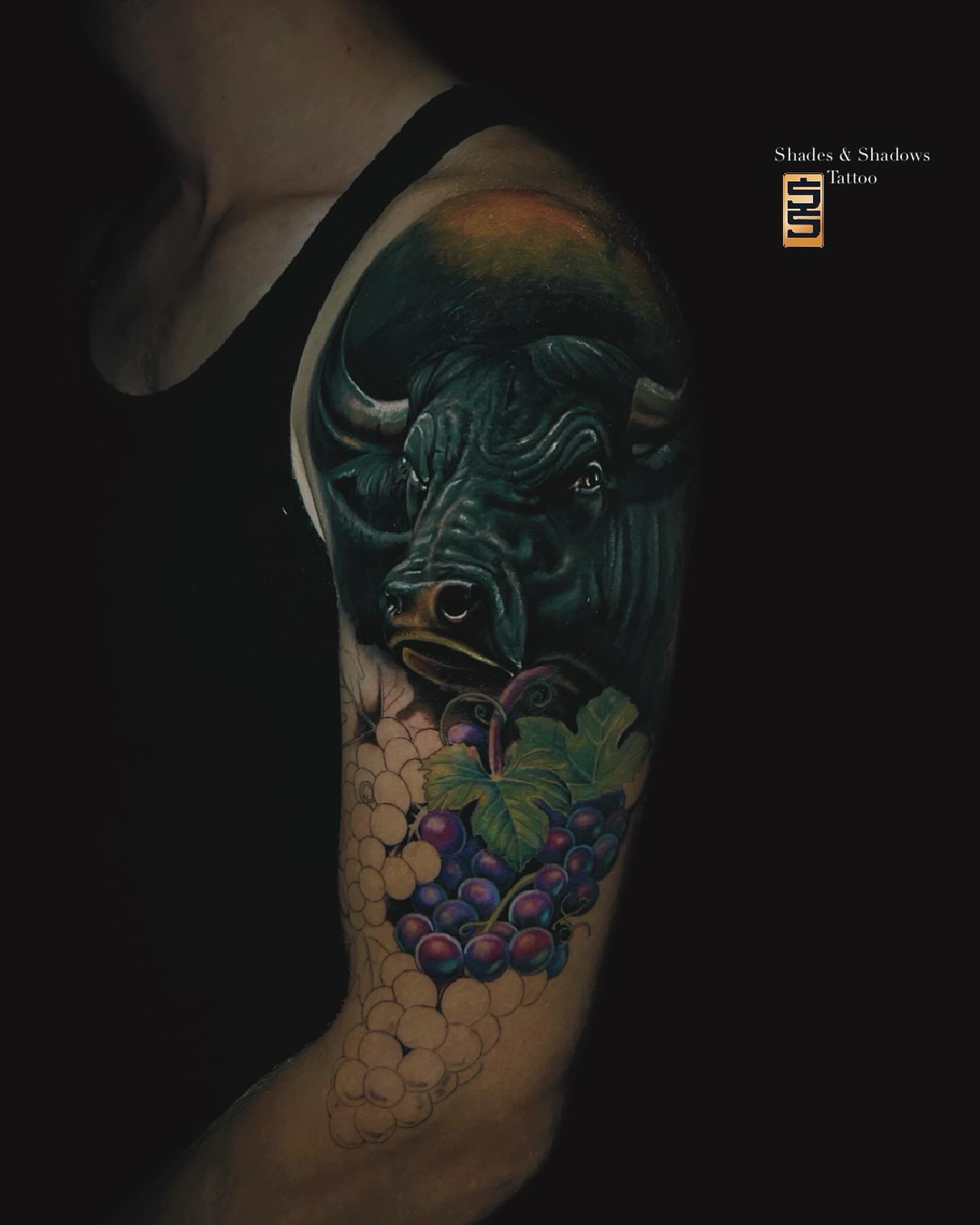 Bull and grapes realism tattoo on the forearm by Austin Tattoo Artist