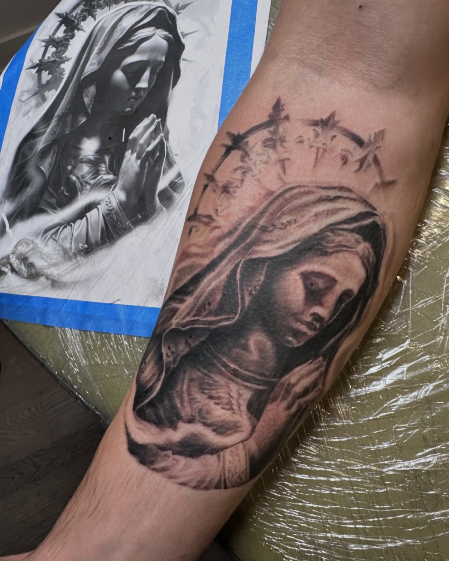 Religious figure praying realism tattoo on the forearm by Matthew Clanin