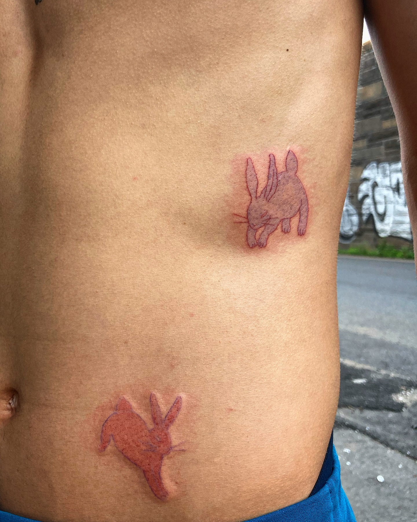 Rabbits American traditional tattoo on the ribs by 잡초
