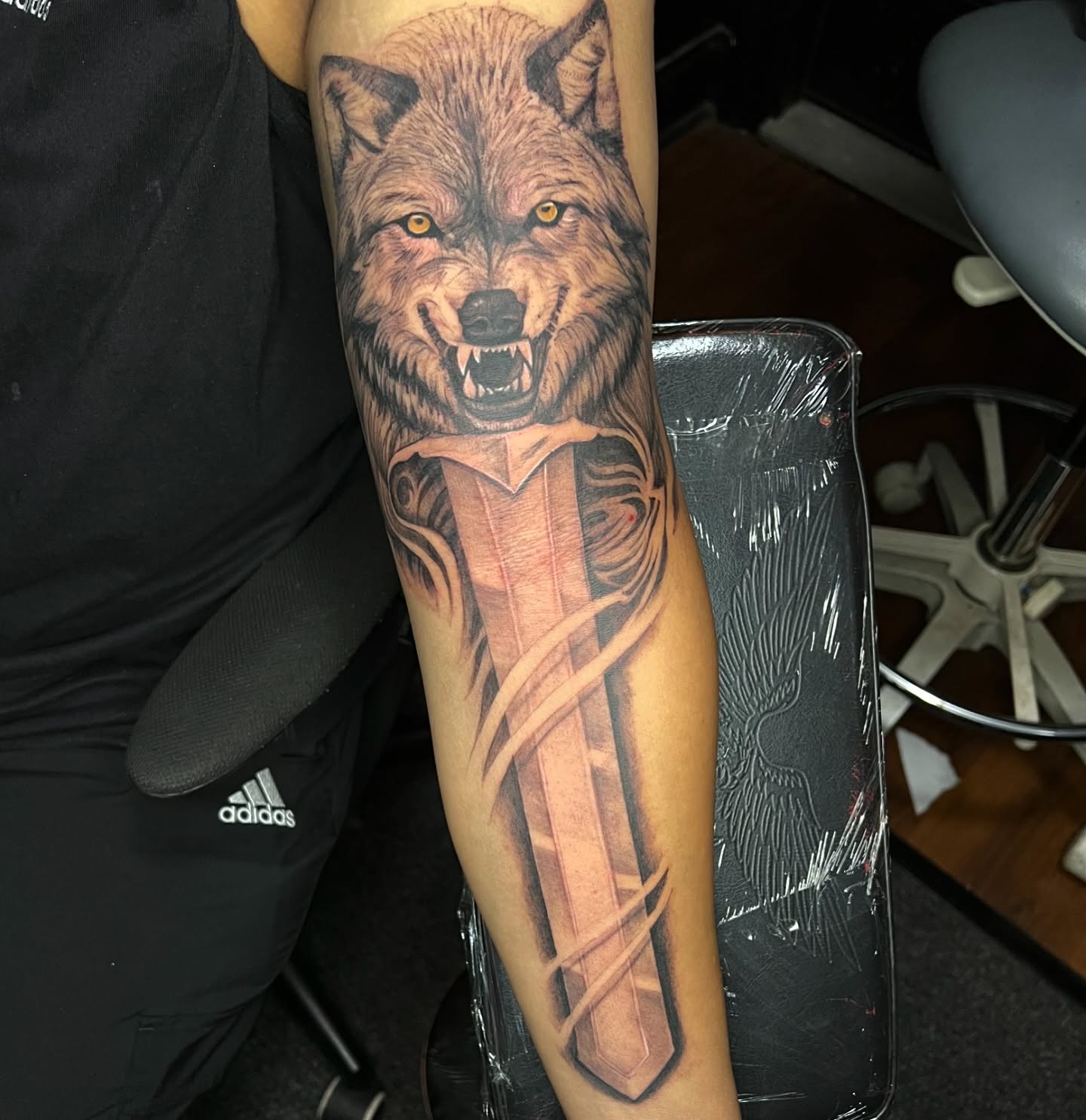 Wolf and sword realism tattoo on the forearm by JT Ink