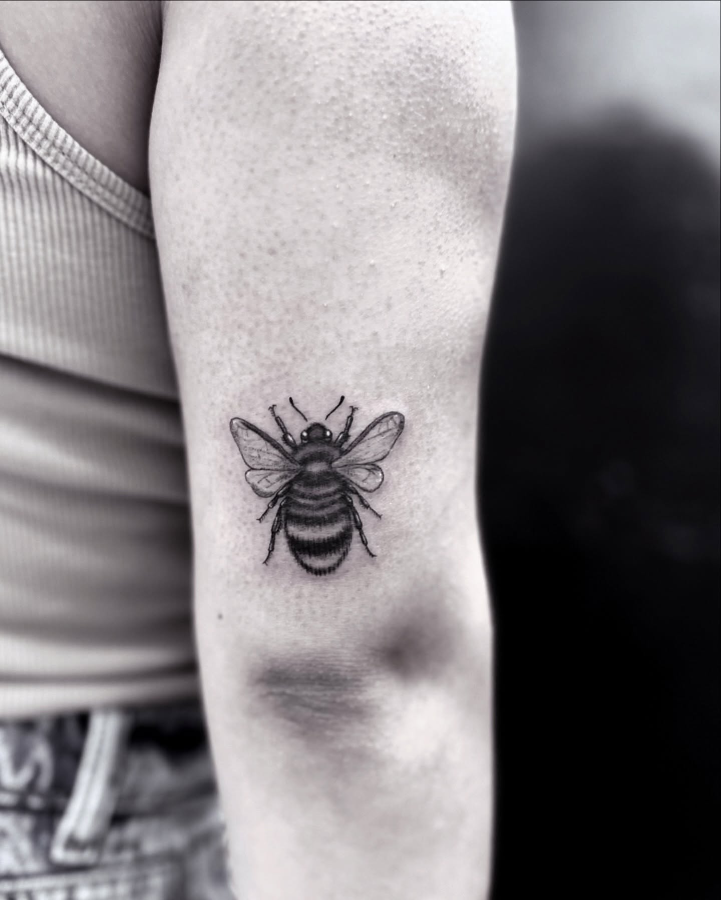 Bee black and grey tattoo on the forearm by Roxanne Ochoa