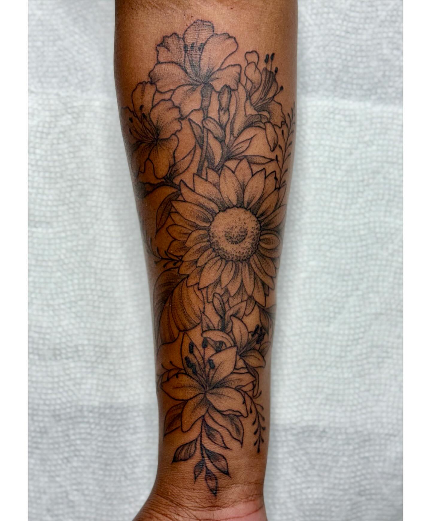 Sunflower bouquet black and grey tattoo on the forearm by Lacee-Beth Finch