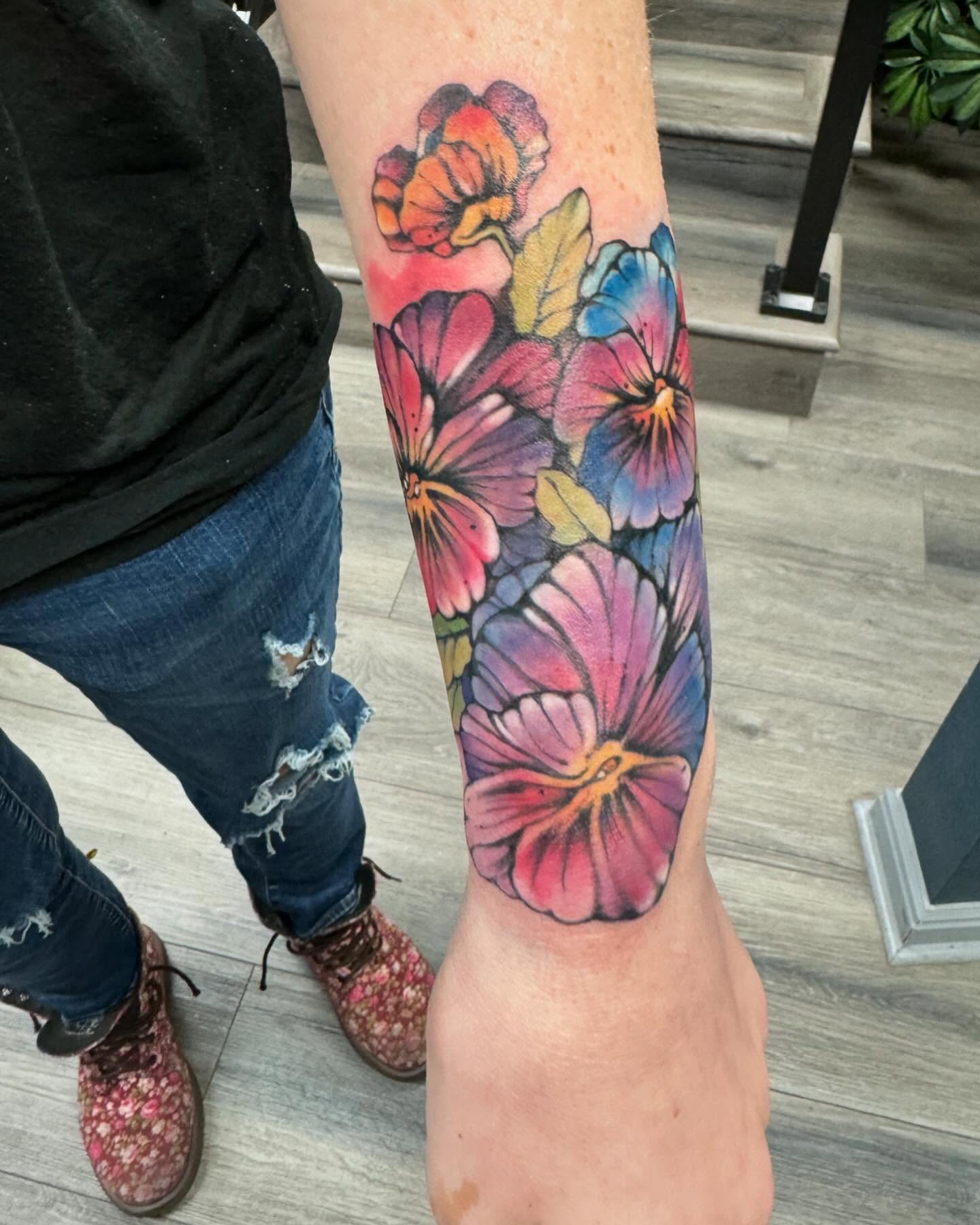 Pansies watercolor tattoo on the forearm by Robyn Mahon