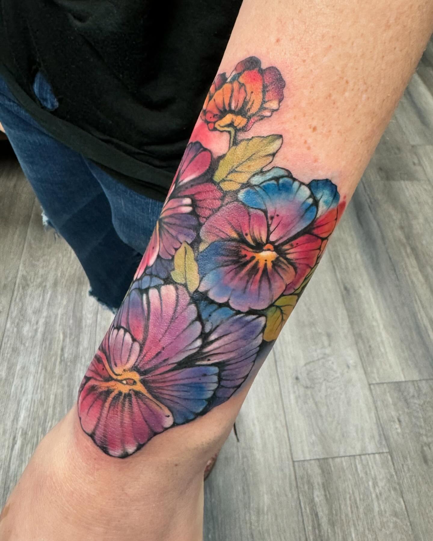 Pansies watercolor tattoo on the forearm by Robyn Mahon