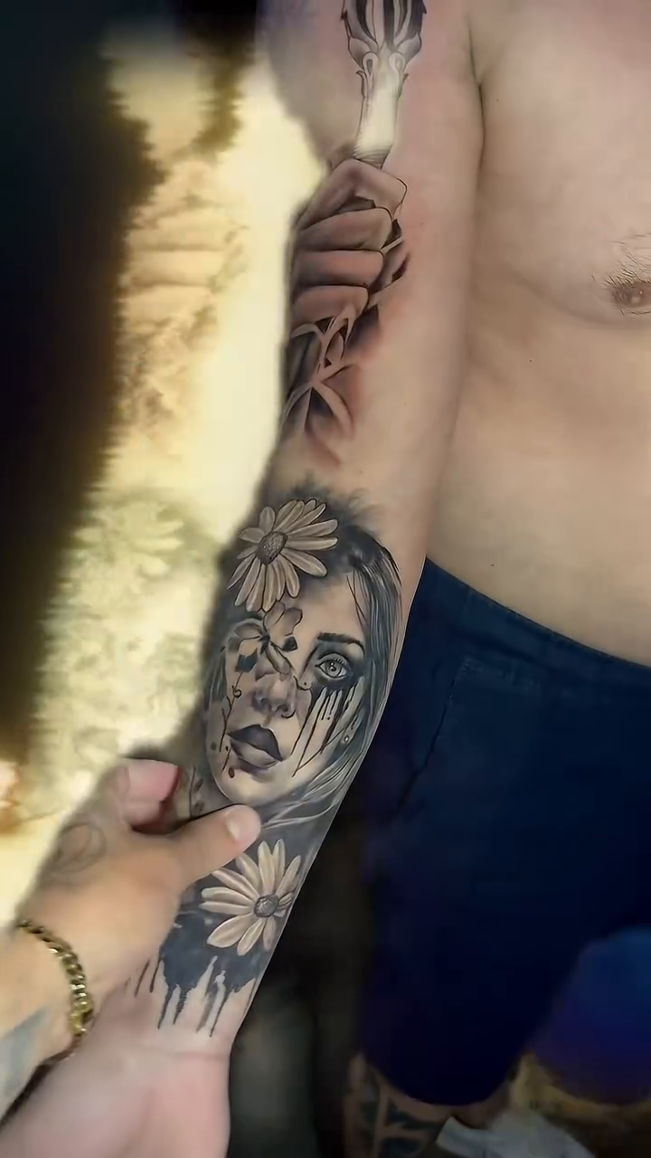 Woman's face and flowers realism tattoo by Alfonso Duenas